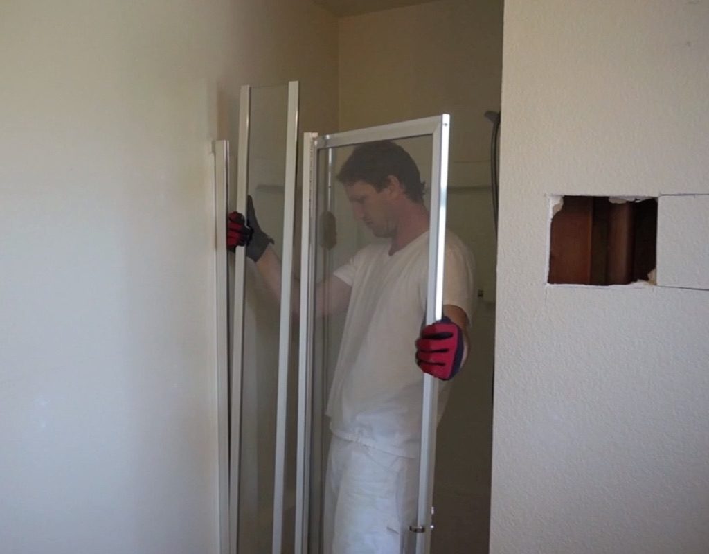 Man removing shower door