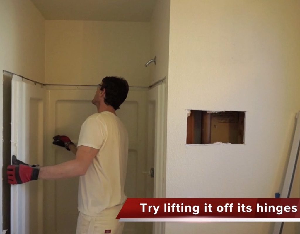 worker removing shower stall walls