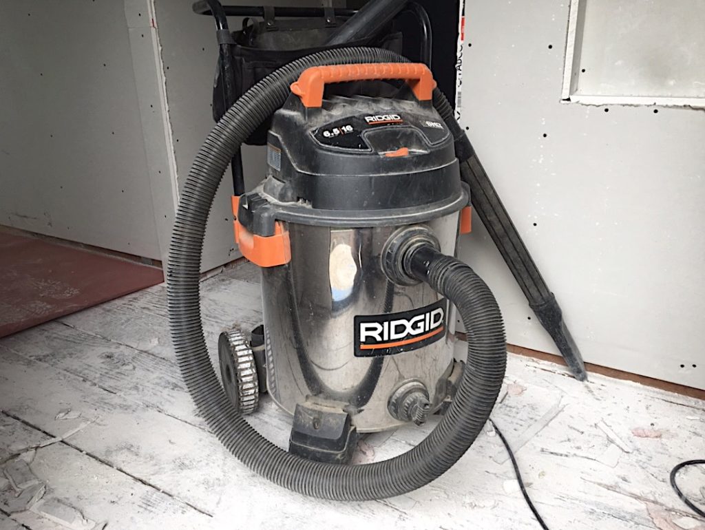 The Ridgid stainlesss steel shop vac covered in drywall dust.