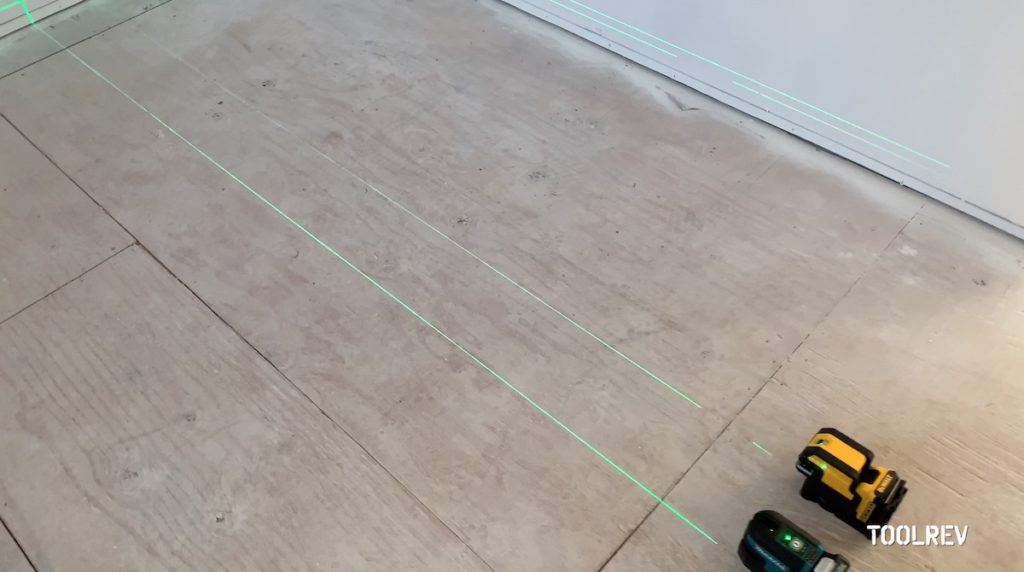 Two laser level lines on wood floor