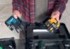 Man holding two laser levels .