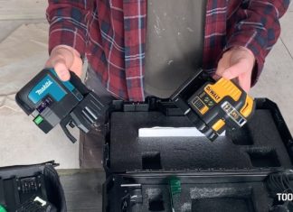 Man holding two laser levels .
