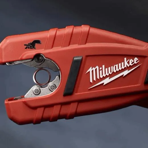 milwukaee copper cutter in red coloring holding a copper tube