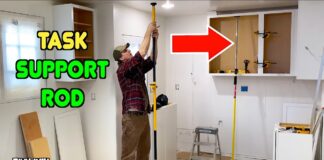 Task support rod holding up a kitchen cabinet during construction.
