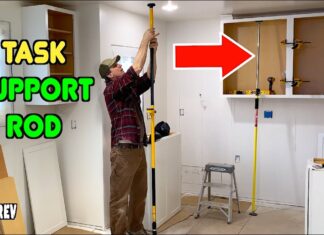 Task support rod holding up a kitchen cabinet during construction.