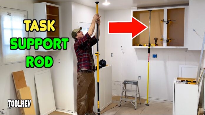 Task support rod holding up a kitchen cabinet during construction.