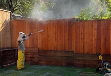 DeWalt 3300 PSI 2.4 GPM Pressure Washer Power Man pressure washing a fence.