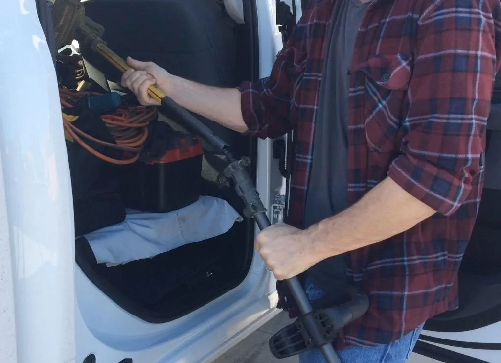 DeWalt weed trimmer being broken down into two halves. DeWalt weed trimmer being broken down into two halves.