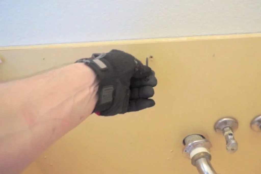 Removing a wood screw from the back of a bathroom vanity Removing a wood screw from the back of a bathroom vanity