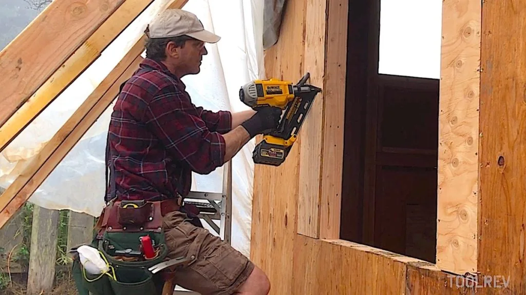 DeWalt 20V cordless framing nailer fastening sheathing on a wall