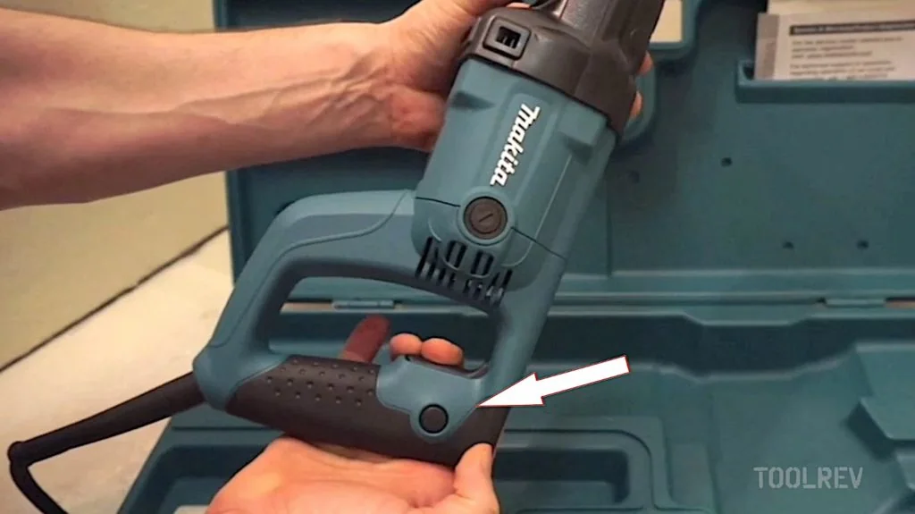 Lock-on button on the handle of a Makita corded reciprocating saw Lock-on button on the handle of a Makita corded reciprocating saw