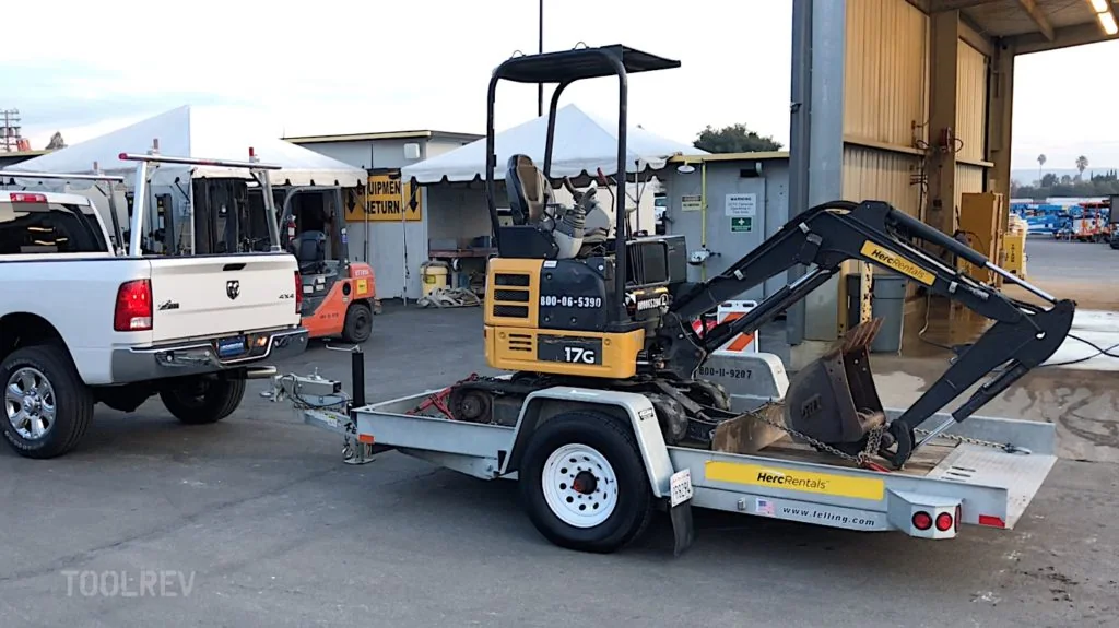 John Deere 17G mini excavator on a trailer behind a pickup
