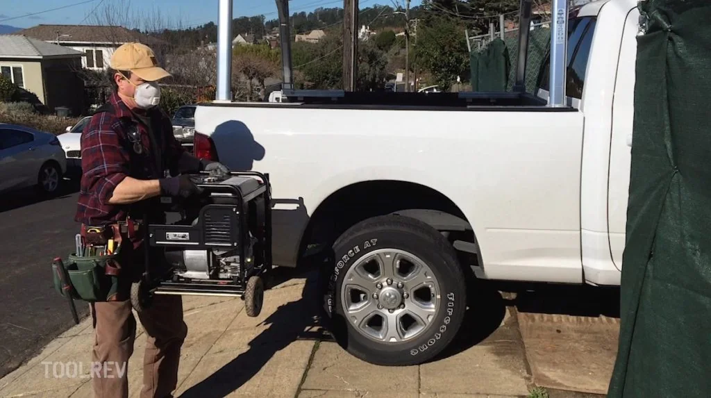 Carrying a Honda EG2800i generator beside a pickup truck