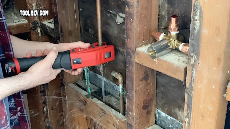 Milwaukee copper cutter cutting water pipe.