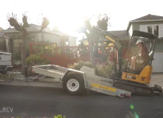 How to Rent and Operate a Mini Excavator Rental mini excavator on a trailer behind a pickup truck in a driveway